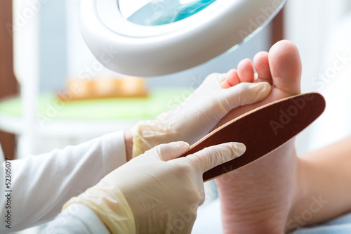 Photo: Woman receiving podiatry treatment in Day Spa Woman receiving podiatry treatment in Day Spa
