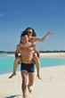Photo: happy young couple enjoying summer on beach happy young couple enjoying summer on beach