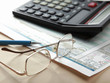 pen and calculator on stocks