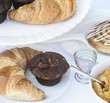 Continental breakfast table setting with pastries and cakes