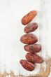 roasted cocoa chocolate beans macro on white wood background