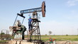 oil worker climbs up to the pump jack