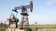 oil worker standing on pump jack