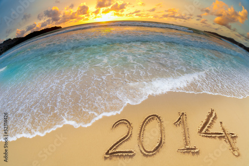 Photo: new year 2014 digits on ocean beach sand new year 2014 digits on ocean beach sand