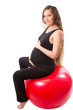 Pregnant fitness woman doing exercise on fitball