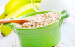 Photo: Oat flakes in the green bowl with banana and milk Oat flakes in the green bowl with banana and milk