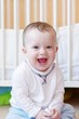 happy smiling baby against white bed