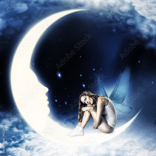 Photo: fairy with wings sitting on moon fairy with wings sitting on moon