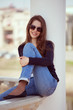 Photo: Charming woman in glasses and blue jeans Charming woman in glasses and blue jeans
