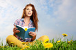 Photo: beautiful girl with book on grass beautiful girl with book on grass