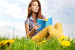 beautiful girl with book on grass