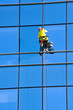 Washer wash the windows of modern skyscraper
