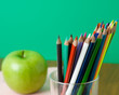 Foto: Glasses with paencils and green apple Glasses with paencils and green apple