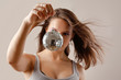 Foto: girl with disco ball, isolated on grey background girl with disco ball, isolated on grey background