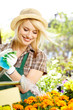 Florists woman working with flowers at a greenhouse.