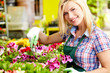 Florists woman working with flowers at a greenhouse.