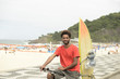 Photo: Surfer African descendant bicycle Ipanema Beach Rio de Janeiro Surfer African descendant bicycle Ipanema Beach Rio de Janeiro