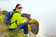 Resting hiker  sitting on the stone