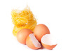 Several eggs and pasta on a white