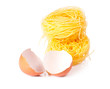 Several eggs and pasta on a white