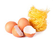 Several eggs and pasta on a white