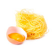 Several eggs and pasta on a white