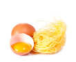 Several eggs and pasta on a white