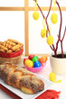 Easter sweet bread with multicolored eggs and shortbread cookies