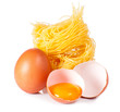 Several eggs and pasta on a white