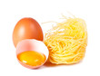 Several eggs and pasta on a white