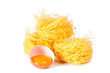 Several eggs and pasta on a white