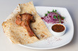 Juicy meat on bone with onions, served with sauce