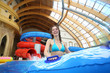 Smiling woman with swimming toy at the water park.