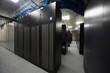 Server room with telecommunication racks and lots of cables.