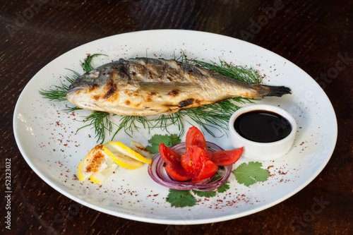 Photo: Grilled fish with tomato, herbs, onions and lemon Grilled fish with tomato, herbs, onions and lemon