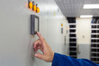 Photo: A man presses a button control on equipment for telecom. A man presses a button control on equipment for telecom.