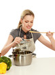 Woman in apron sitting on the desk with grocery bag