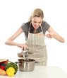Woman in apron standing near desk with grocery bag