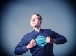 Businessman showing a superhero suit underneath his suit