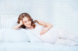 Pregnant woman lying on bed