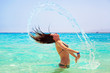 Foto: Young brunette jumping out of turquoise water of Red Sea, Egypt Young brunette jumping out of turquoise water of Red Sea, Egypt