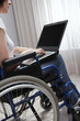 Foto: Disabled young woman using laptop Disabled young woman using laptop