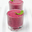 Blueberry smoothie with mint in a glass beaker