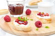 Toasted baguette with cream cheese, raspberry jam
