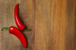 wooden background with red hot chili peppers, horizontal