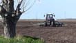 Tractor sowing and cultivating field