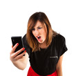 Young woman shouting to her mobile phone.