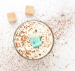 Foto: White cup of whipped cream with chocolate, on a white background White cup of whipped cream with chocolate, on a white background
