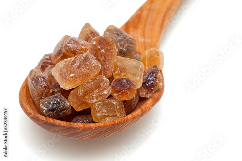 Photo: brown caramelized sugar on white background brown caramelized sugar on white background