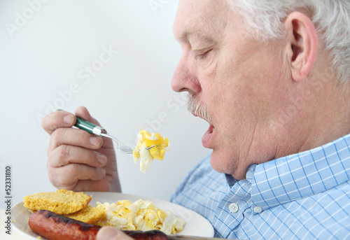 Photo: senior eats breakfast eggs senior eats breakfast eggs